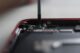 Professional repair of a smartphone's internal components using precise tools.