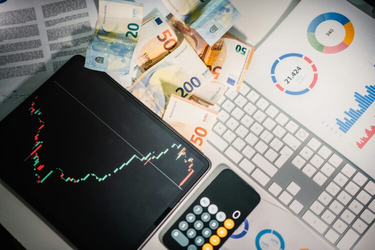 A calculator sitting on top of a pile of money